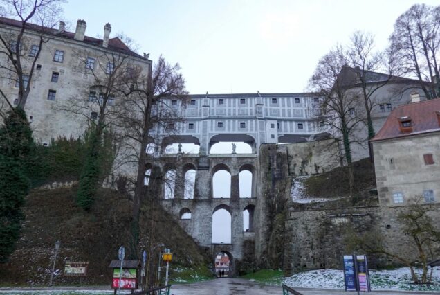 Explore the Cloak Bridge at Český Krumlov Castle, showcasing stunning Baroque architecture in winter.